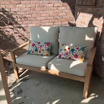 Outdoor Loveseat with Cushions on Brick Patio